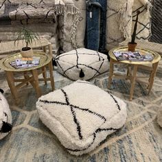 a living room filled with lots of furniture and rugs on top of a floor