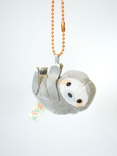 a stuffed slotty hanging from a ball chain