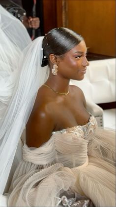 a woman in a wedding dress sitting down