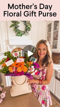 a woman holding a bouquet of flowers in front of a kitchen counter with the words mother's day floral gift purse