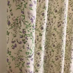 a curtain with purple and green flowers on it