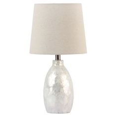 a lamp with a white shade on top of it and a light bulb in the middle