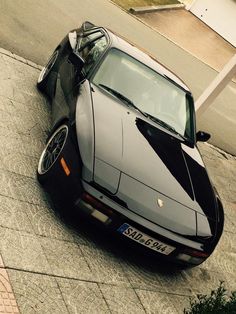 a black sports car is parked on the street