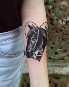 a woman's arm with a tattoo of a horse on the left side of her arm