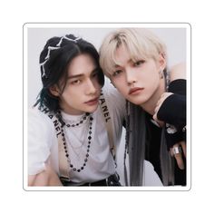 two young men are posing together for a photo in front of a white background and one is wearing a necklace