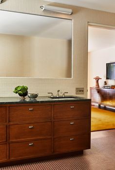 a bathroom with two sinks and a large mirror over the sink in front of it