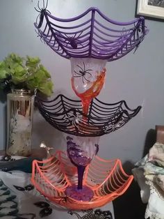 there is a purple and orange glass sculpture on the table