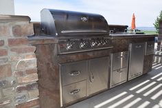 an outdoor bbq with grill and umbrella