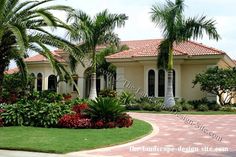 a large house with palm trees and landscaping