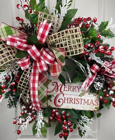 a merry christmas wreath hanging on the front door