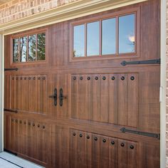 a wooden garage door is shown with windows