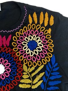 Beautifully hand embroidered shirts made in Mexico by our artisan partners who are expert embroiderers. Each shirt will come in the color you pick with the embroidery slightly varying in colors. This shirt will be a staple in your wardrobe / store!Runs SMALL. Order 1-2 sizes larger. Large & XL are the best sellers. Traditional Short Sleeve Embroidered Top With Tonal Embroidery, Traditional Embroidered Cotton T-shirt, Black Cotton Top With Geometric Embroidery, Custom Embroidered Long Sleeve T-shirt, Traditional Cotton T-shirt With Multicolor Embroidery, Traditional Multicolor Embroidery Cotton T-shirt, Black Cotton Tops With Machine Embroidery, Multicolor Embroidered Text Crew Neck T-shirt, Traditional Multicolor Embroidered Cotton T-shirt