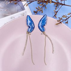 Material: Metal Trendy Light Blue Drop Earrings, Trendy Light Blue Dangle Earrings, Trendy Blue Dangle Earrings, Trendy Light Blue Party Jewelry, Trendy Light Blue Jewelry For Party, Light Blue Earrings For Party, Trendy Blue Drop Earrings, Kawaii Earrings, Butterfly Wing Earrings