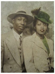 an old photo of two people wearing hats