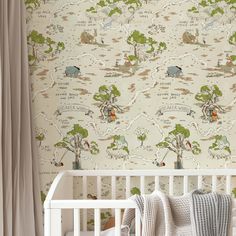 a baby's crib in front of a wallpaper with animals and trees