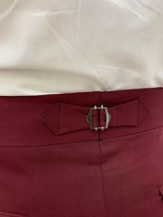 Introducing the Burgundy Buckled Canvas Trousers, designed for the modern man seeking elegance and comfort. These versatile trousers seamlessly transition from tailored business attire to smart-casual wear, making them ideal for formal events or everyday outfits. Crafted from a premium mix of 68% Viscose, 30% Polyester, and 2% Lycra, they offer both a stylish appearance and exceptional comfort. The slim-fit cut enhances your profile while ensuring ease of movement, making these trousers a wardro Fitted Business Pants With Belt Loops, Tailored Suits With Belt Loops For Semi-formal Occasions, Red Elegant Formal Dress Pants, Elegant Red Formal Dress Pants, Tailored Red Dress Pants For Formal Occasions, Semi-formal Slim Fit Bottoms With Belt Loops, Formal Slim Fit Bottoms With Belt Loops, Semi-formal Flat Front Bottoms With Belt Loops, Classic Fitted Bottoms With Belt Loops