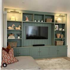 a living room filled with furniture and a flat screen tv on top of a wooden entertainment center