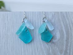 This pair of blue and aqua/sea foam sea glass earrings features 6 pieces of small sized aqua/green, clear, and blue sea glass (each piece is different shapes and tones).  The weight is not heavy, comfortable to wear. The dangle drops are  about 1" (30mm)long the 1/2" (20) wide. You can choose the earrings hooks or posts style in the "hook material" option.  I offer solid sterling silver hooks, stainless steel hooks, and stainless steel posts (shown as picture, the loops/jump rings that connectin Handmade Blue Sea Glass Earrings, Blue Teardrop Sea Glass Earrings, Blue Sea Glass Nickel Free Earrings, Blue Sea Glass Nickel-free Earrings, Nickel-free Blue Sea Glass Earrings, Blue Sea Glass Dangle Jewelry, Blue Recycled Glass Dangle Earrings, Sea Glass Earrings, Blue Sea Glass