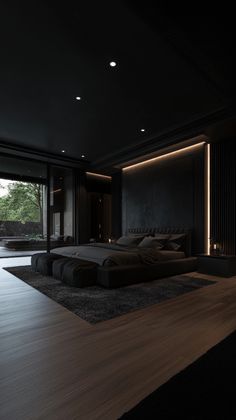 a large bed sitting in the middle of a room next to a window with lights on it