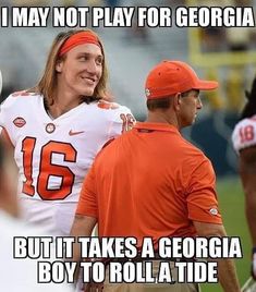 a man in an orange bandana is talking to another man on the sidelines