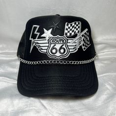 Route 66 and checkered flag Trucker Hat with Hat chain INCLUDED! Black Trucker Hat  5 Panel Trucker Hat  Foam Front  Mesh Back   Adjustable back  Perfect for: Indy 500 Racing Hat 4 th of July Mother's Day Fathers Day  Baby shower Summer hat Boat hat Trendy hat Patchy hat Custom Trucker Hats Unique Truckers Western style Cheap Black Trucker Hat With Embroidered Logo, Black Biker Cap, Adjustable Cap For Biker Events, Adjustable Black Motorcycle Hat, Black Motorcycle Cap, Baby Shower Summer, Hat Chain, 4 Th Of July, Boat Hat