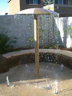 an outdoor fountain with water spouting from it