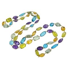 14 Karat Yellow Gold Bezel Set Multicolor Gemstone Necklace Featuring Blue Topaz, Amethyst, Citrine, and Prasiolite. The Necklace Measures 36 Inches Long. Bezel Setting, Gemstone Necklace, Blue Topaz, Citrine, Topaz, Gold Necklace, Multi Color, Amethyst, Yellow Gold