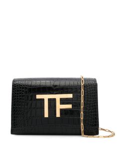 logo-plaque leather cluch bag from TOM FORD featuring black, calf leather, embossed crocodile effect, gold-tone logo plaque, foldover top with press-stud fastening, chain-link shoulder strap, multiple internal slip pockets and partitioned compartment. Size Info UNI Color Detail Black Made In Italy Material Calf leather 100% Season One Fall-Winter Season Two Fall-Winter Product bags.. Brand Tom Ford Size And Fit Width 8,27 in / 21 cm Height 5,51 in / 14 cm Depth 2,56 in / 6,5 cm Strap 44,09 in / Elegant Tan Bag With Logo Hardware, Leather Clutch Bag With Gold-tone Logo Plaque, Business Rectangular Shoulder Bag With Metal Logo, Evening Clutch Bag With Logo Plaque, Evening Clutch Bags With Logo Plaque, Evening Clutch With Logo Plaque, Luxury Tan Rectangular Clutch, Rectangular Office Shoulder Bag With Metal Logo, Luxury Clutch Bag With Logo Plaque