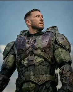 a man in a futuristic suit looks off into the distance