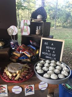 a table topped with lots of different types of snacks and candys next to a sign that says, be a bunny in the world of smalls