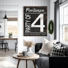 a living room filled with furniture and a sign on the wall above it's coffee table