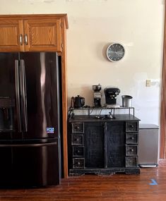 a black refrigerator freezer sitting inside of a kitchen