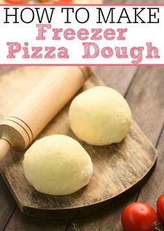 two pizza doughs sitting on top of a wooden cutting board next to tomatoes and a rolling pin