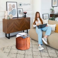 a woman sitting on a couch using a laptop computer