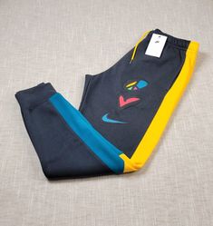 NIKE Jogger Pants Medium XL 2XL  Mens Peace Love Basketball Gray Blue Yellow BRAND NEW WITH TAGS COLOR: GRAY BLUE YELLOW MEN'S SIZES AND MEASUREMENTS MEDIUM Waist: 15 inches ( across ) Length: 39 inches Inseam: 28 inches XL Waist: 17 inches ( across ) Length: 40 inches Inseam: 29 inches 2XL Waist: 18 inches ( across ) Length: 41 inches Inseam: 29 inches Shipped with USPS Priority Mail except on weekends and holidays. * Please note, USPS is experiencing an increase in packages. Delivery times may Nike Blue Pants For Jogging, Blue Nike Pants For Jogging, Nike Blue Jogging Pants, Blue Nike Joggers For Jogging, Nike Multicolor Sports Bottoms, Nike Multicolor Casual Bottoms, Nike Casual Multicolor Bottoms, Casual Multicolor Nike Bottoms, Sporty Yellow Color Block Bottoms