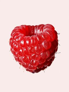 a bunch of raspberries sitting on top of each other in the shape of a heart