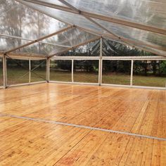 the inside of a large tent with wooden floors