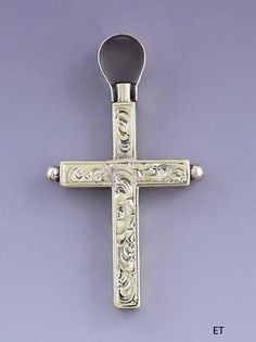 Presented is a fabulous 14 karat gold watch key fob or pendant in the form of a cross. This piece dates to around the 1850s-1870s and is likely of European make, possibly Swiss or French. The cross is beautifully hand engraved on all sides, with delicate scrolled foliate designs on the front and back and diamond diaperwork on the sides. The cross slides up to reveal a watch key end, about a size 7 by our estimate, compared to example watch keys in varying sizes. This is a really exceptionally we Antique Collectible Crucifix Jewelry, Antique Crucifix Collectible Jewelry, Antique Collectible Cross Jewelry, Antique Cross Jewelry With Large Pendant, Antique Hallmarked Crucifix Jewelry, Victorian Engraved Crucifix Jewelry, Historical Yellow Gold Engraved Jewelry, Antique Hallmarked Cross Pendant Jewelry, Victorian Hallmarked Cross Pendant Jewelry