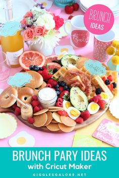 a pink table topped with plates and cups filled with fruit, veggies and cookies