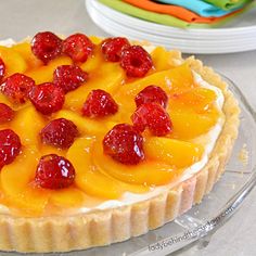 a fruit tart on a clear plate