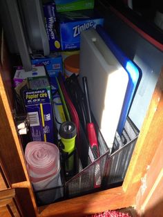 the drawer is full of various items and things that are left out on the floor