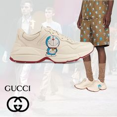 Brand New In Box Gucci X Doraemon Rhyton Sneakers Size: 40 Color: Ivory So You've Heard That A Cat Always Lands On Its Feet, Right? Well Lucky For You These Rhyton Sneakers From A Collaborative Effort Between Doraemon And Gucci Will Always Keep You Grounded. Thanks To A Chunky Ridged Rubber Sole You'll Always Feel Steady Walking The Roughest Streets. Made In Italy Highlights: Leather Round Toe Panelled Design Front Lace-Up Fastening Logo Patch At The Tongue Branded Insole Ridged Rubber Sole Dora Gucci Yellow Sneakers With Round Toe, Gucci Designer Sneakers With Embroidered Logo, Gucci Custom Lace-up Sneakers With Logo Print, Gucci Lace-up Sneakers With Logo Detail, Gucci Lace-up Sneakers With Embroidered Logo, Bee Shoes, Green Trainers, Brown Leather Sneakers, Rainbow Sneakers