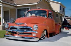 an orange truck parked in front of a house