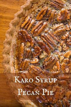 a pecan pie on a wooden table with the words karo syrup pecan pie