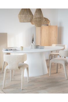 a white table with four chairs around it