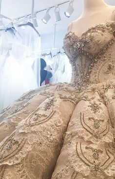 a mannequin is shown in front of a dress on display at a bridal shop