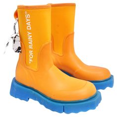 Get your hands on the Off-White Orange & Blue Rubber Boots—an edgy and playful addition to your footwear collection that defies convention and brings a burst of energy to rainy days. The boots feature a striking orange hue, instantly capturing attention and infusing a sense of playfulness into your ensemble. The bold color choice ensures that you stand out on even the gloomiest of days. Adding a dynamic touch, the bright blue accent enhances the visual appeal of the boots. This thoughtful color Orange Boots, Chanel Hat, Gucci Jacket, Blue Accent, Rubber Boot, Cooler Look, Footwear Collection, Rubber Boots, Bold Color