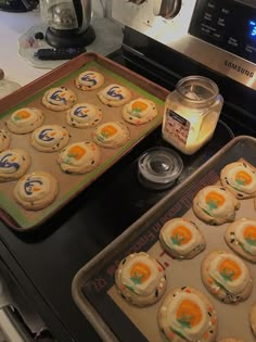 some cookies are sitting on a baking sheet next to a cookie tin and an oven