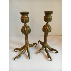 two metal candlesticks sitting on top of each other in the shape of octopus legs