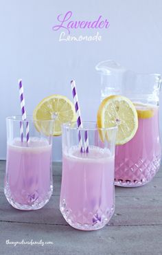 three glasses filled with lemonade and two purple striped straws next to each other